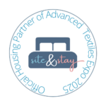 Site&Stay_Logo Circular logo featuring a bed icon with "site & stay" in playful blue and pink text, surrounded by "Official Housing Partner of Advanced Textiles Expo 2025."