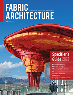A vibrant red architectural structure with a dramatic overhang, set against a mountainous landscape under a clear blue sky.