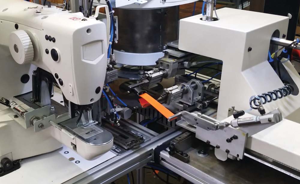 Fully automatic buckle insertion & turn-tack sewing station Image